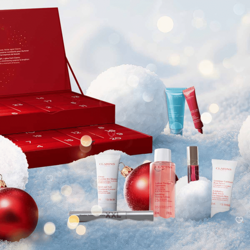 Clarins Adventskalender 2025 mit 24 Luxus-Minis für Gesicht, Körper und Make-up in festlicher roter Geschenkbox.