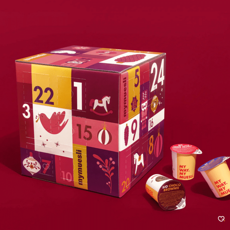 Muesli 2-go Adventskalender 2025 mit 24 Bio-Müslis in Bechern, 12 exklusiven Sorten und festlicher Gourmet-Box.