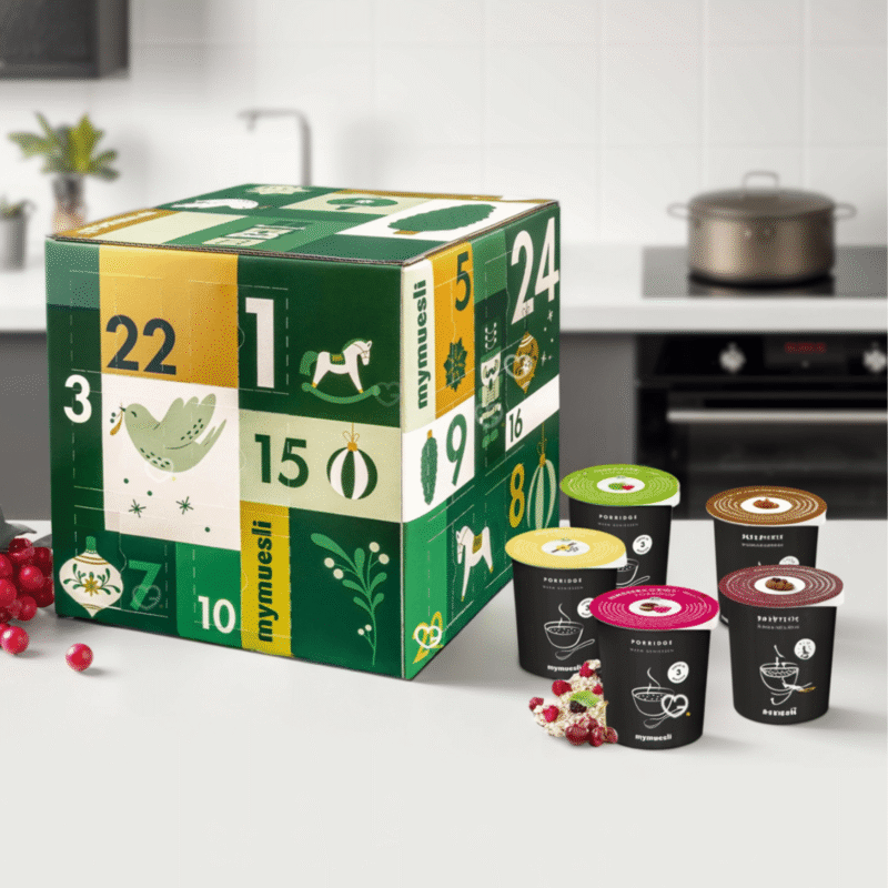 Mymuesli Porridge Adventskalender 2025 mit 24 Bio-Sorten, 18 exklusiv, festliche Box mit Gutschein für Genießer:innen.