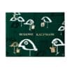 Susanne Kaufmann Adventskalender 2026, geschlossene Box flach liegend, grüner Deckel mit Vogelmotiv und goldenem Logo