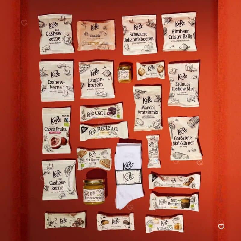 Alle 24 Snacks der Classic Edition des KoRo Adventskalender 2026 mit KoRo-Socken