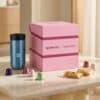 Nespresso Original Adventskalender 2026 mit rosa Box, Swarovski-Reisebecher und Kaffeekapseln in der Küche